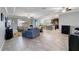 Open living room with tile floors and a view into the kitchen at 14822 Trinity Fall Way, Bradenton, FL 34212