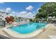 Refreshing community pool with surrounding lounge chairs at 1553 Pleasant Rd # H27, Bradenton, FL 34207