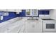 Modern kitchen with white cabinets, blue backsplash and granite counters at 1553 Pleasant Rd # H27, Bradenton, FL 34207