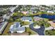 Aerial view of a residential neighborhood with a lake and houses at 1608 Honey Ct, Venice, FL 34293