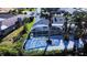 Aerial view of a home with a screened-in pool and a large palm tree at 1608 Honey Ct, Venice, FL 34293