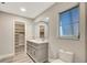 Bathroom with double vanity and walk-in closet at 1608 Honey Ct, Venice, FL 34293