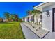 Modern home exterior, featuring a walkway, landscaping, and a gray driveway at 1608 Honey Ct, Venice, FL 34293