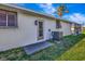 White house with dark gray shutters, landscaping, and a gray driveway at 1608 Honey Ct, Venice, FL 34293