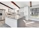 Modern kitchen with white shaker cabinets, gray countertops, and stainless steel appliances at 1608 Honey Ct, Venice, FL 34293