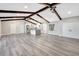 Open concept living space with exposed wooden beams and gray vinyl flooring at 1608 Honey Ct, Venice, FL 34293