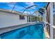 Inviting screened pool with blue tile and a view at 1608 Honey Ct, Venice, FL 34293