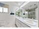 Bathroom with double sinks and a shower/tub combination at 1928 Greenlawn Dr, Englewood, FL 34223