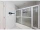 Bathroom with shower/tub combo and a sliding glass door at 1928 Greenlawn Dr, Englewood, FL 34223