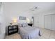 Bedroom with a queen bed, two nightstands, and a ceiling fan at 1928 Greenlawn Dr, Englewood, FL 34223