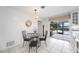 Breakfast nook with glass table and black metal chairs. Views of pool at 1928 Greenlawn Dr, Englewood, FL 34223