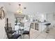 Kitchen with a breakfast nook, white cabinetry, and a view of pool at 1928 Greenlawn Dr, Englewood, FL 34223