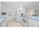 White kitchen with blue countertops and stainless steel appliances at 1928 Greenlawn Dr, Englewood, FL 34223