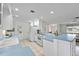 Spacious kitchen with island, white cabinets and light blue countertops at 1928 Greenlawn Dr, Englewood, FL 34223