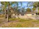 Home's backyard with wooden fence and palm trees at 1947 W Leewynn Dr, Sarasota, FL 34240