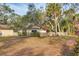 Landscaped backyard with large tree and fence at 1947 W Leewynn Dr, Sarasota, FL 34240