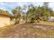 Large backyard with mature trees and partial fencing at 1947 W Leewynn Dr, Sarasota, FL 34240