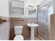 Clean bathroom with shower stall, pedestal sink, and toilet at 1947 W Leewynn Dr, Sarasota, FL 34240