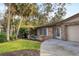 Side view of the house showing brick facade and landscaping at 1947 W Leewynn Dr, Sarasota, FL 34240