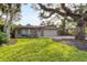 House exterior featuring a two-car garage and lush lawn at 1947 W Leewynn Dr, Sarasota, FL 34240