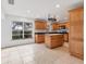 Kitchen with wood cabinets, an island, and tile floors at 1947 W Leewynn Dr, Sarasota, FL 34240