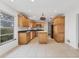 Eat-in kitchen, featuring wood cabinets and an island at 1947 W Leewynn Dr, Sarasota, FL 34240