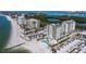 Aerial view of beachfront condos with pools and lush landscaping at 2050 Benjamin Franklin Dr # A601, Sarasota, FL 34236