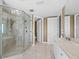 Spa-like bathroom with a large glass shower and marble floors at 2050 Benjamin Franklin Dr # A601, Sarasota, FL 34236