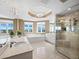 Luxurious bathroom with a soaking tub, walk-in shower, and water views at 2050 Benjamin Franklin Dr # A601, Sarasota, FL 34236