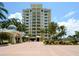 Condo building with palm trees and paved courtyard at 2050 Benjamin Franklin Dr # A601, Sarasota, FL 34236