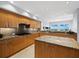 Gourmet kitchen featuring granite counters and wood cabinetry at 2050 Benjamin Franklin Dr # A601, Sarasota, FL 34236