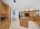 Modern kitchen with granite countertops and wood cabinets at 2050 Benjamin Franklin Dr # A601, Sarasota, FL 34236