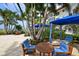 Relaxing patio area with shaded seating and ocean views at 2050 Benjamin Franklin Dr # A601, Sarasota, FL 34236