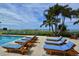 Relaxing pool area with lounge chairs and ocean view at 2050 Benjamin Franklin Dr # A601, Sarasota, FL 34236