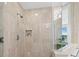 Walk-in shower with marble tile and glass enclosure at 2050 Benjamin Franklin Dr # A601, Sarasota, FL 34236