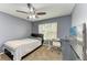 Bright bedroom with a bed, desk, and large TV at 223 Heritage Isles Way, Bradenton, FL 34212