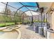 Screened lanai with pool, spa, and patio furniture at 223 Heritage Isles Way, Bradenton, FL 34212