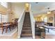 Elegant staircase with dark wood treads and a chandelier above at 223 Heritage Isles Way, Bradenton, FL 34212