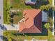 Top-down view of a single-story house with a brown tile roof and screened enclosure at 2421 Palomar St, North Port, FL 34287