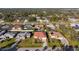 Aerial view showcasing a house with a red roof amongst other houses and trees at 2421 Palomar St, North Port, FL 34287