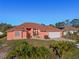 Single-story house with a peach exterior, brown roof, and attached garage at 2421 Palomar St, North Port, FL 34287