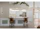 Kitchen with white cabinets, breakfast bar, and tile floor at 2421 Palomar St, North Port, FL 34287