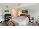 Bedroom with a queen bed, bookshelf, and tiled floors at 2723 Orchid Oaks Dr # 104, Sarasota, FL 34239