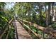 Wooden boardwalk path through lush vegetation at 2723 Orchid Oaks Dr # 104, Sarasota, FL 34239