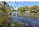 Tranquil waterfront view of a canal with lush trees at 2723 Orchid Oaks Dr # 104, Sarasota, FL 34239