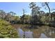 Scenic canal view with lush, tropical vegetation at 2723 Orchid Oaks Dr # 104, Sarasota, FL 34239