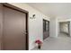 Condo entry with brown door and poinsettia plant at 2723 Orchid Oaks Dr # 104, Sarasota, FL 34239