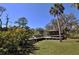 Wooden gazebo nestled amongst the lush greenery at 2723 Orchid Oaks Dr # 104, Sarasota, FL 34239