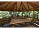 Gazebo interior with a long wooden picnic table at 2723 Orchid Oaks Dr # 104, Sarasota, FL 34239