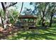 Wooden gazebo with picnic table and benches at 2723 Orchid Oaks Dr # 104, Sarasota, FL 34239